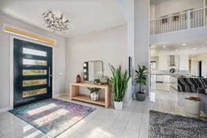 Entrance foyer featuring a chandelier and a high ceiling
