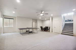 Recreation room with carpet floors, a ceiling fan, and recessed lighting