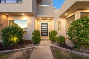 View of exterior entry featuring stucco siding