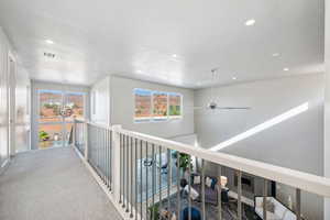 Corridor with recessed lighting and carpet floors