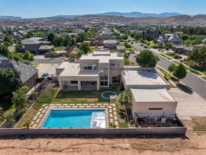 Aerial view of residential area featuring a pool area and mountains