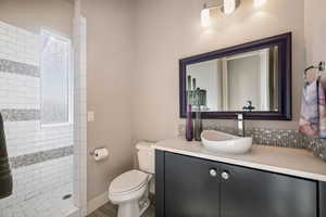 Bathroom with a tile shower and vanity