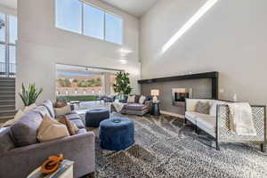 Living area featuring a towering ceiling and stairs