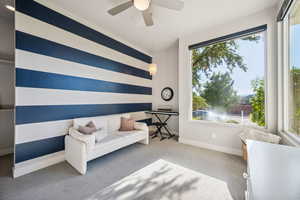 Living area featuring carpet flooring and ceiling fan