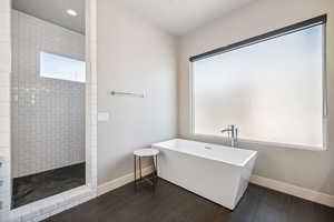 Full bath with a freestanding tub, plenty of natural light, a walk in shower, and recessed lighting