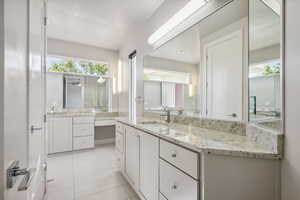 Full bath with vanity and tile patterned floors