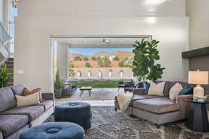 Living area featuring stairs and ceiling fan