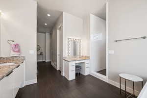Bathroom featuring vanity, a walk in shower, and recessed lighting