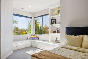 Living area with light colored carpet and baseboards