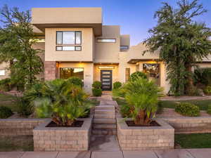 View of front facade featuring stucco siding