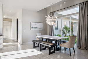 Dining room with a chandelier and recessed lighting