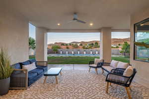 Fenced backyard featuring a patio, ceiling fan, and outdoor lounge area