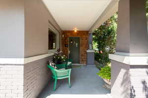 View of exterior entry with covered porch