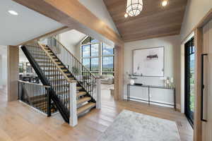 Entrance foyer featuring wooden ceiling, wood-type flooring, recessed lighting, stairway, and high vaulted ceiling