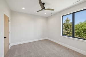 Empty room with carpet flooring, recessed lighting, and a ceiling fan