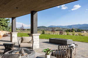 View of patio with a view of countryside and a fire pit