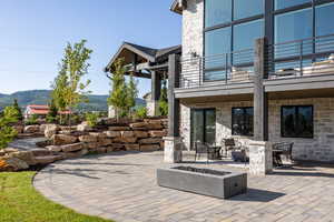 Patio / terrace with a patio area, an outdoor fire pit, and a mountain view