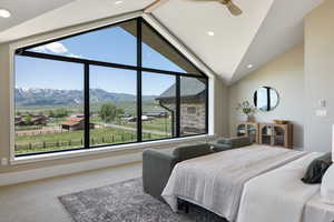 Carpeted bedroom featuring vaulted ceiling, recessed lighting, and a mountain view