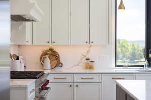 Kitchen featuring appliances with stainless steel finishes and white cabinets