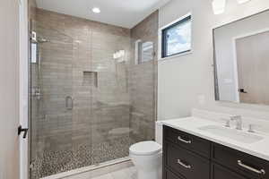 Full bathroom featuring vanity, a shower stall, tile patterned floors, and recessed lighting