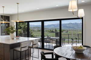 Dining area featuring light wood-style flooring, recessed lighting, and a mountain view