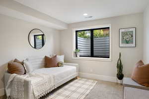 Carpeted bedroom featuring multiple windows and recessed lighting