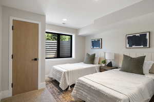 Carpeted bedroom with recessed lighting and baseboards