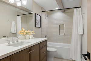Bathroom with vanity, shower / bath combo with shower curtain, and recessed lighting