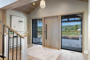 Foyer entrance featuring vaulted ceiling, wood finished floors, a mountain view, wood ceiling, and recessed lighting