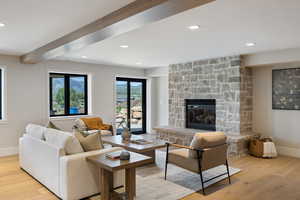 Living area with wood finished floors, recessed lighting, a fireplace, and beam ceiling