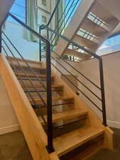 Stairway with baseboards and carpet