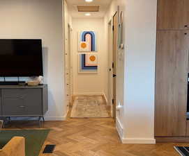 Hallway featuring baseboards and recessed lighting