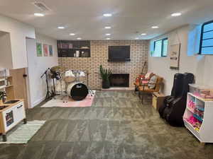Rec room featuring carpet flooring, a brick fireplace, and recessed lighting