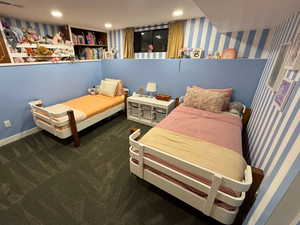 Bedroom featuring carpet floors, wallpapered walls, and recessed lighting
