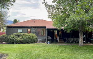 Rear view of property featuring a lawn