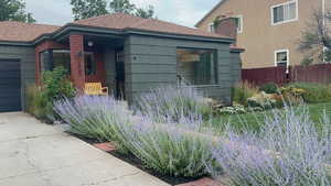 View of side of home featuring a shingled roof