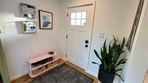 Entrance foyer featuring light wood-style flooring