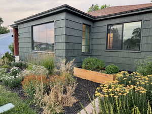 View of property exterior featuring a vegetable garden