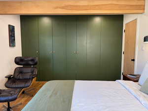 Bedroom featuring wood finished floors and a closet