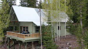 Back of property with a deck and a metal roof