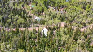 Aerial view of property's location featuring a heavily wooded area