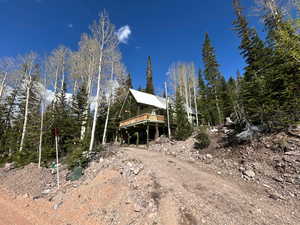 View of side of home featuring a deck