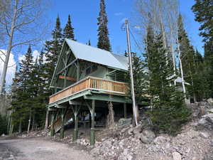 View of front of property with a deck and a metal roof