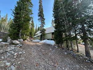 View of side of home with a metal roof