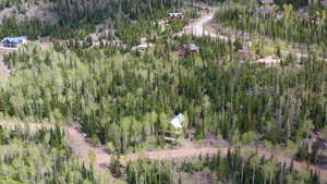 Aerial view of property and surrounding area featuring a heavily wooded area