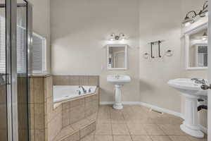 Bathroom featuring a garden tub and tile patterned floors