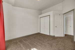 Unfurnished bedroom featuring carpet and a closet