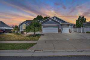 View of front of house with concrete driveway and a garage