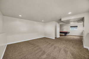 Basement with carpet, billiards table, a textured ceiling, and recessed lighting