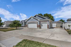 View of front of house with concrete driveway, a garage, and brick siding